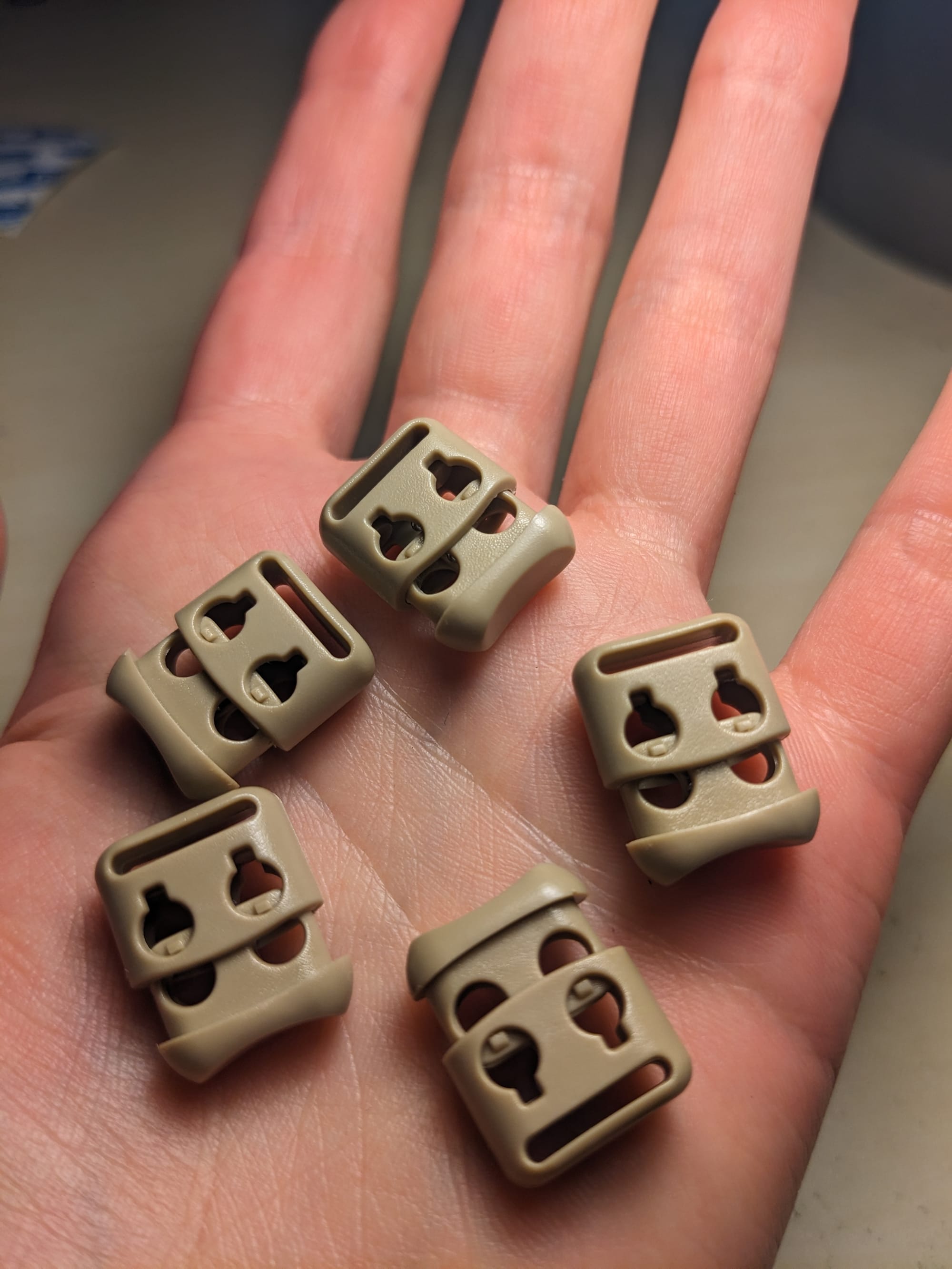 5 beige rectangular drawstring fasteners