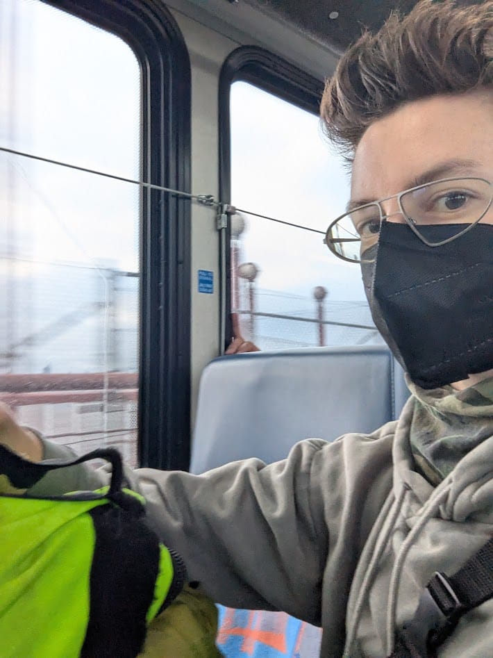 me masked on a bus on the golden gate bridge