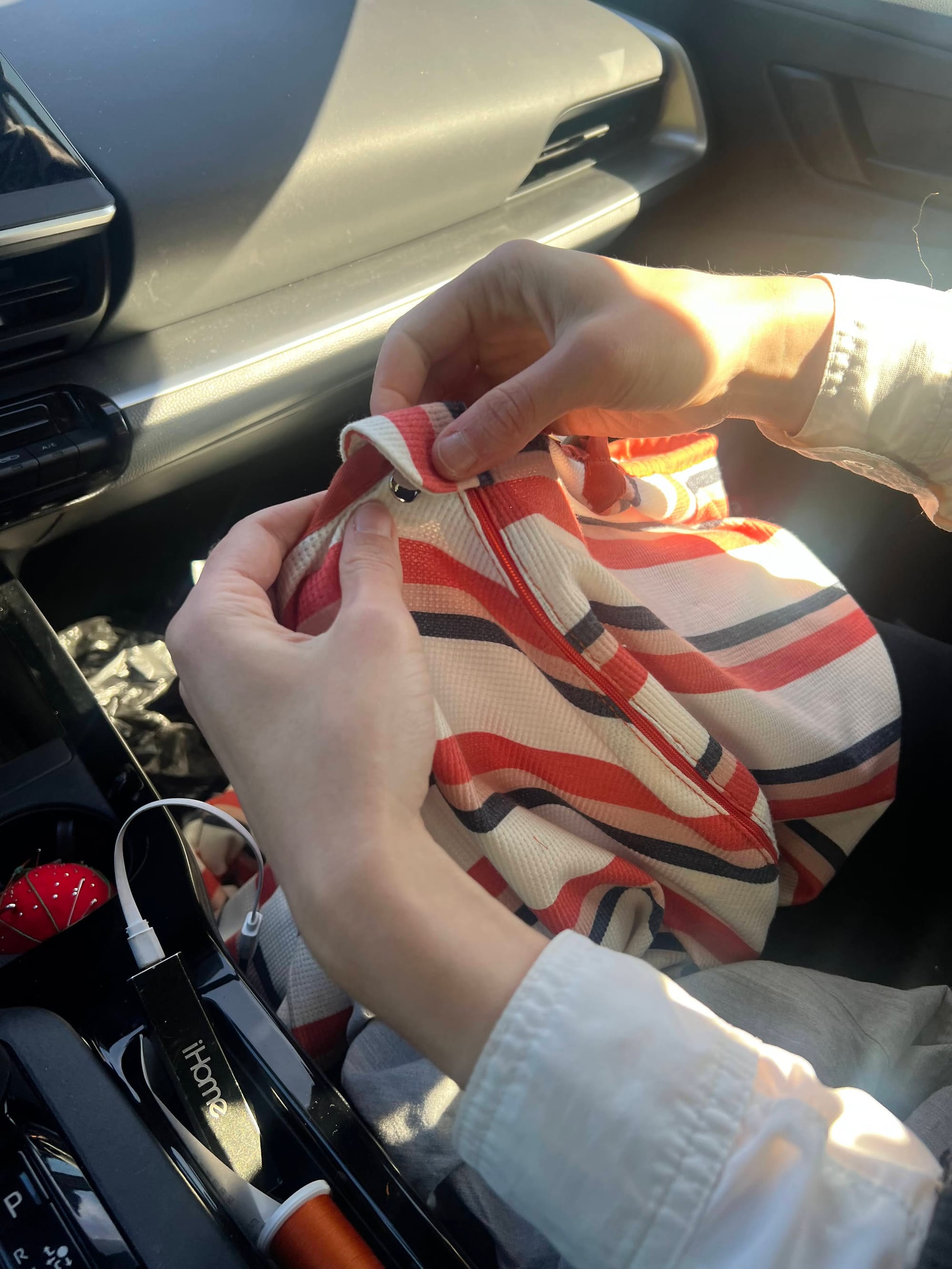 me in the car with a bunch of sewing supplies, finishing the last bits of sewing