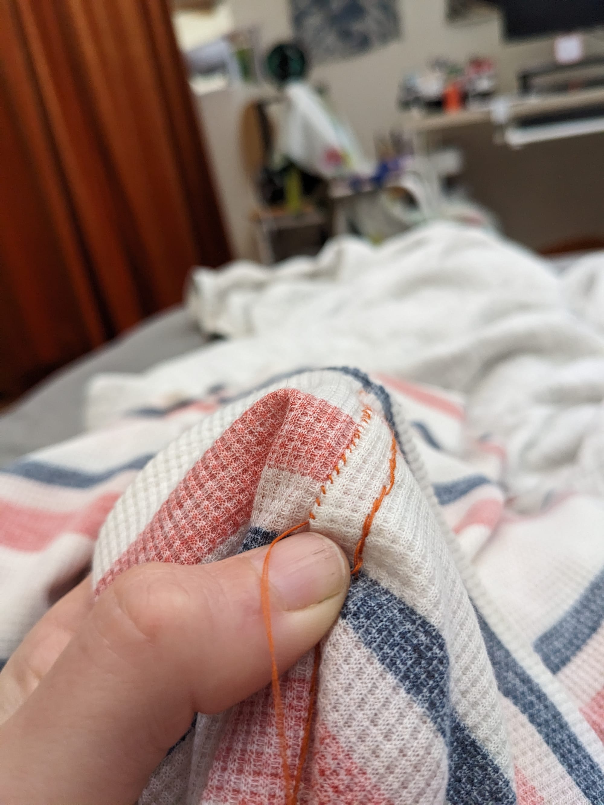 inside of a seam, with a backstitch on one side and tiny felling stitches on the other