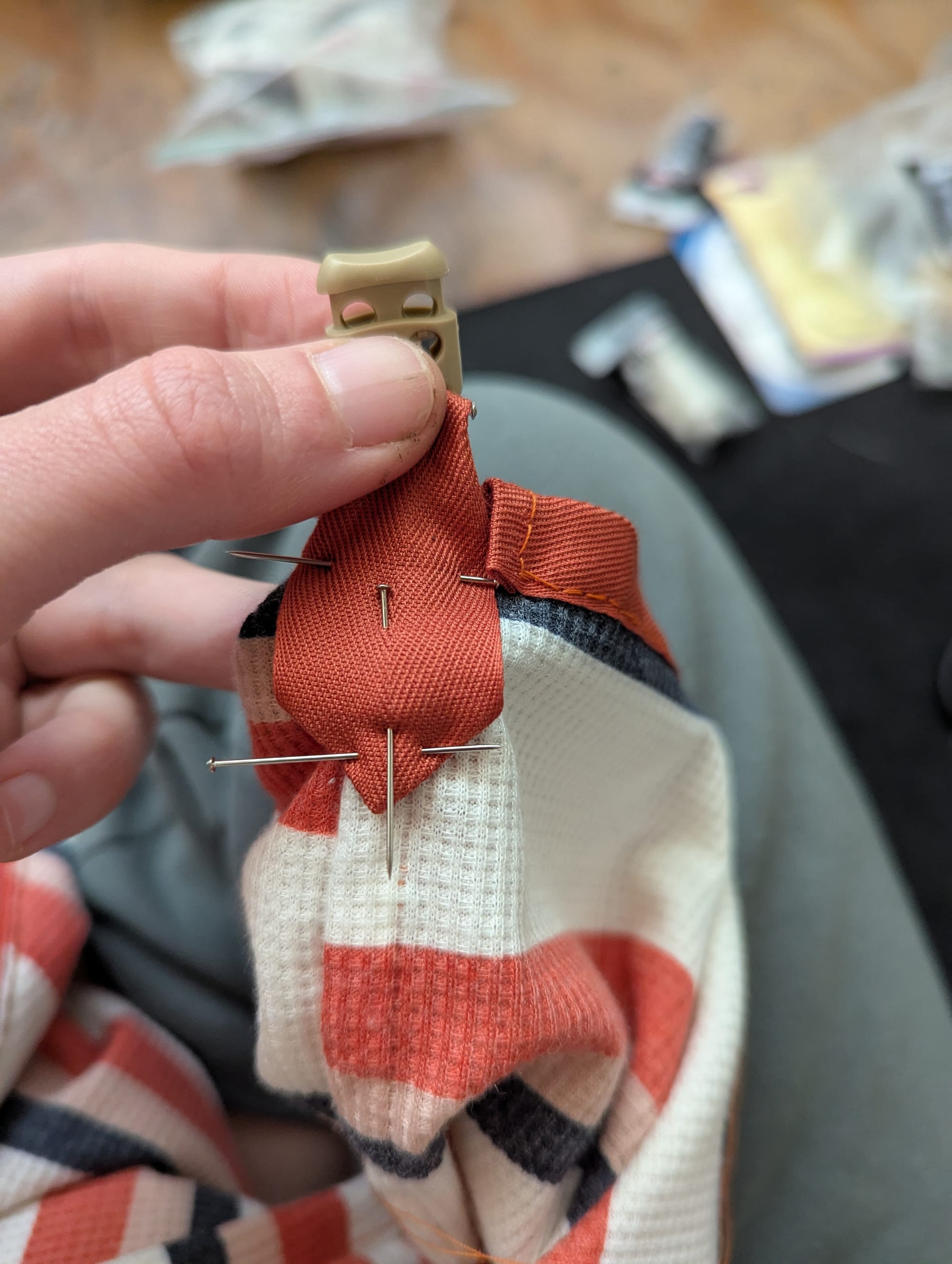 pins holding the bias tape tab onto the bag liner