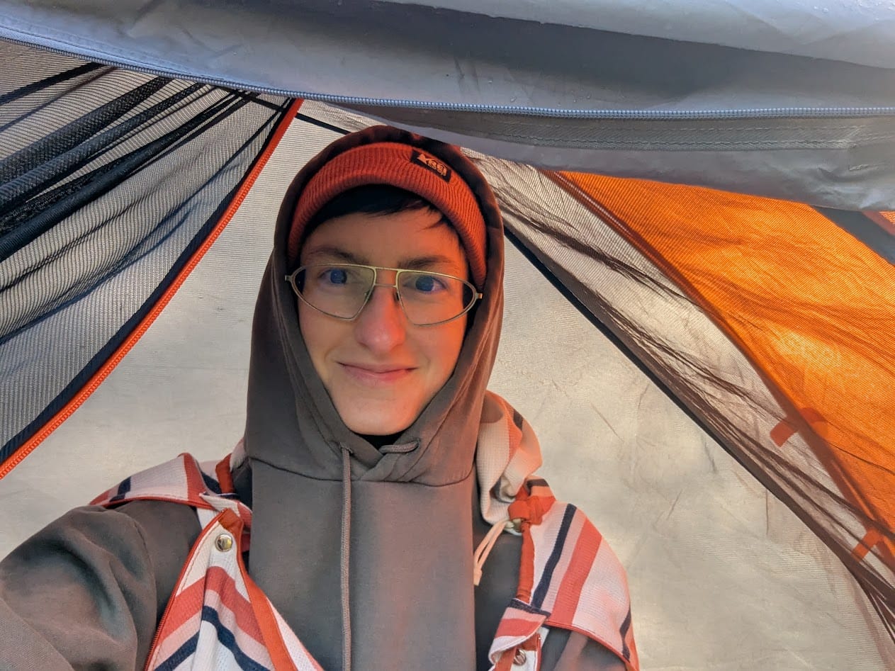 me in my tent bundled up, wearing the bag liner over a hoodie