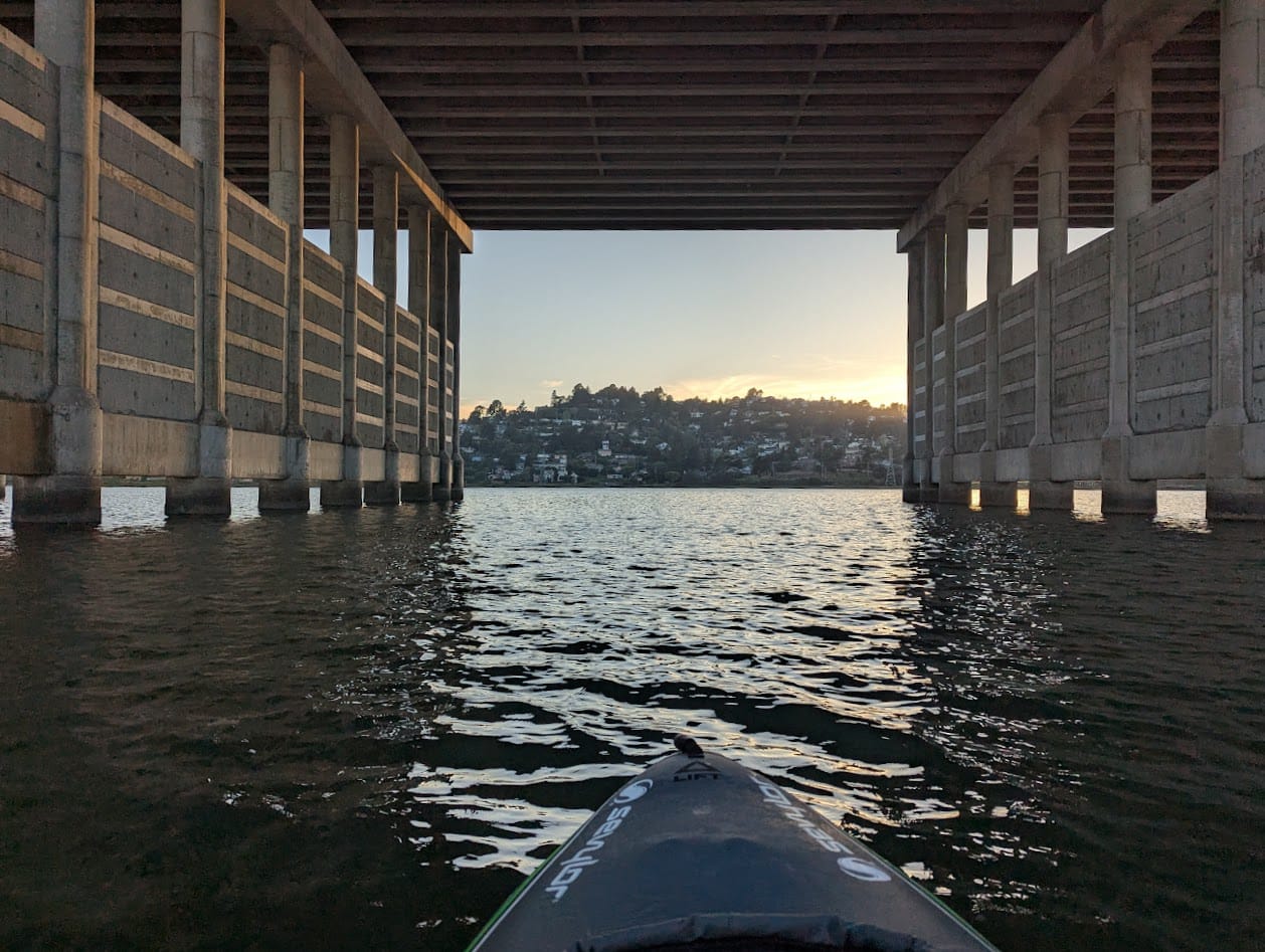 kayak under a bridge