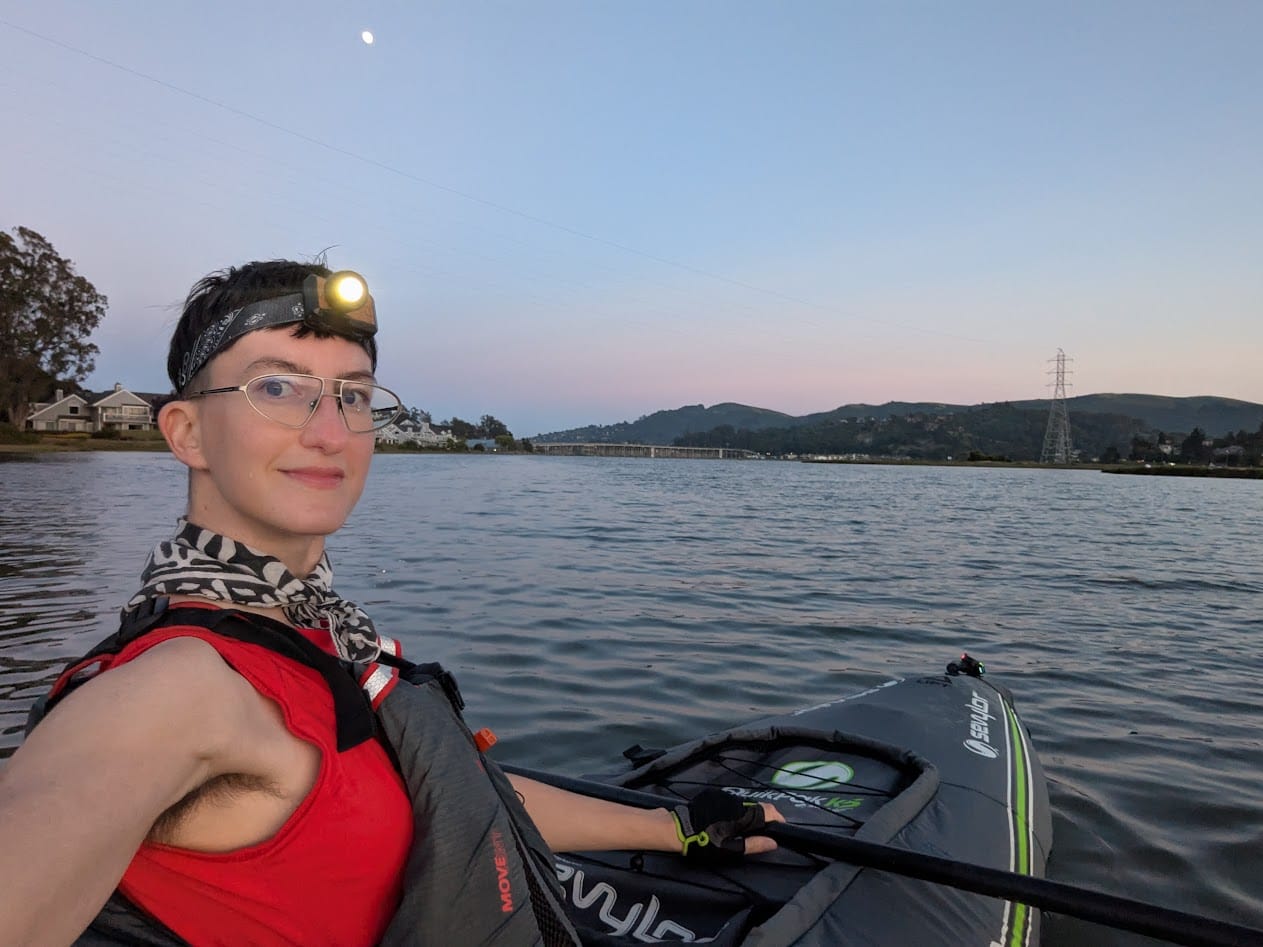 me in my boat with my headlamp on and lights on the front of my kayak