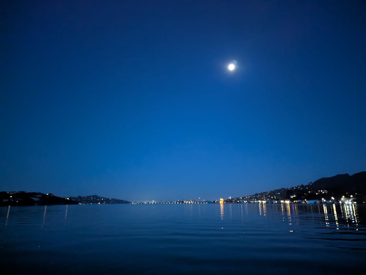 bay at twilight, with an almost full moon