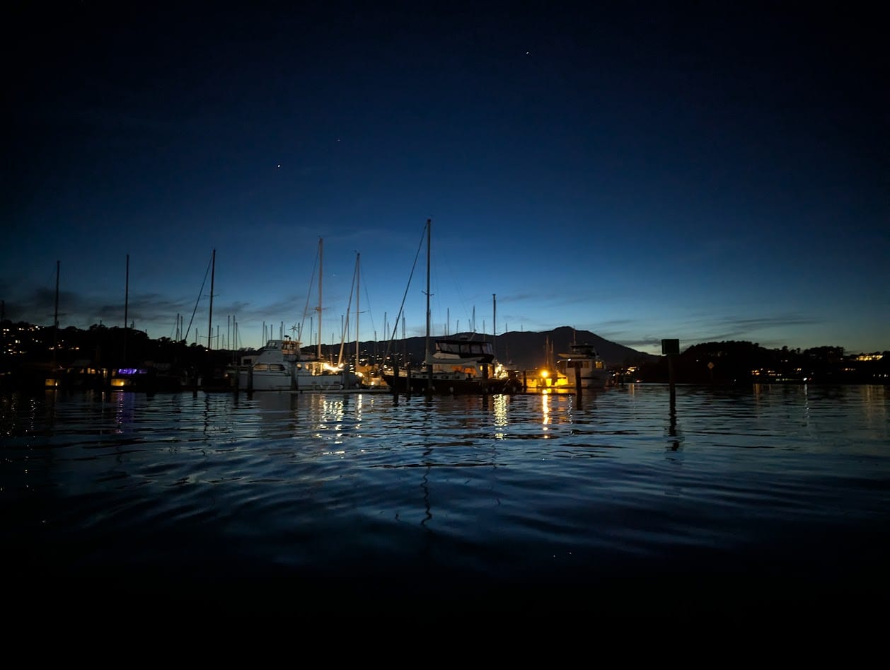 sailboats in a harbor at twilight