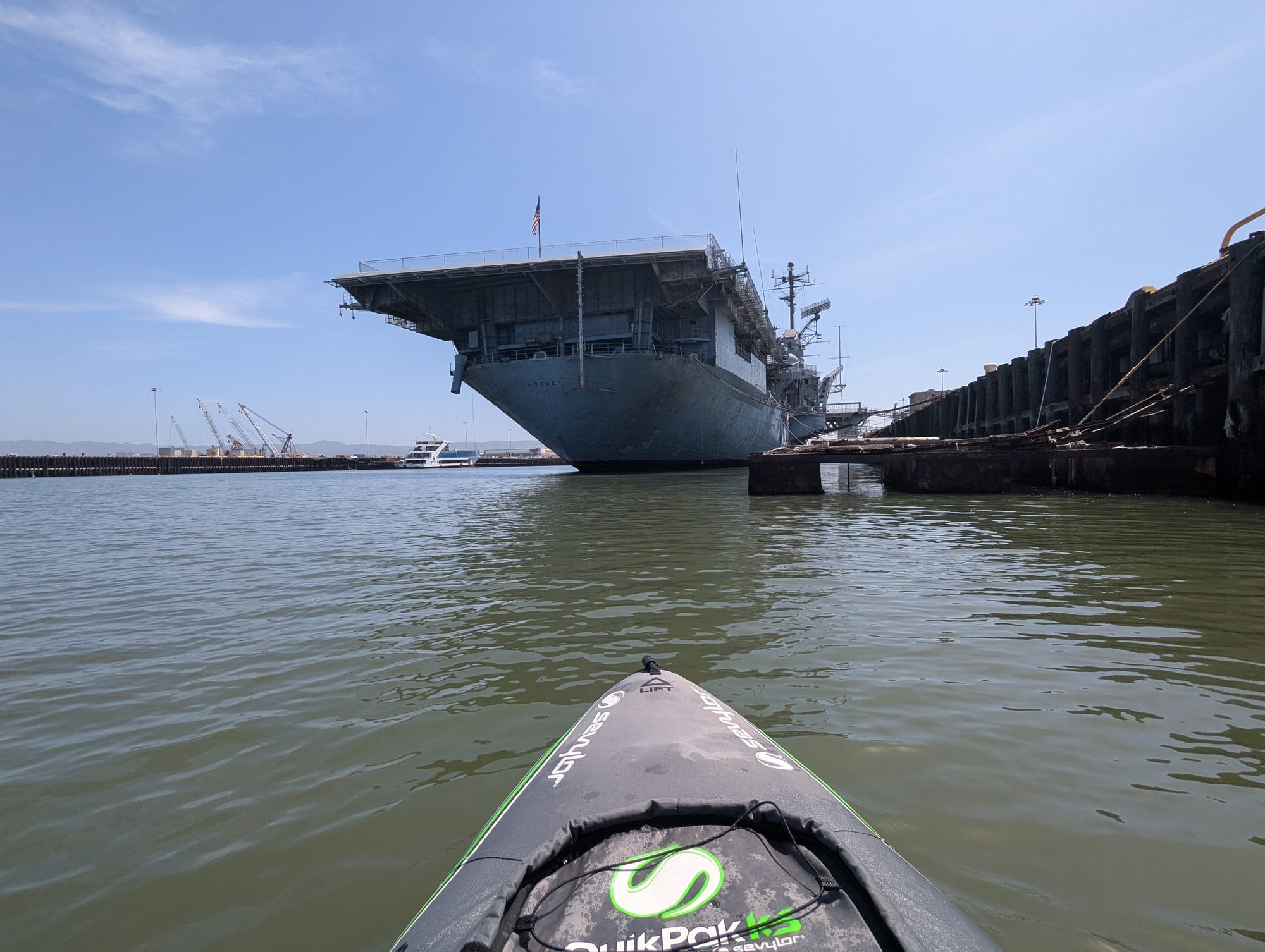 my boat approaching a large wwii aircraft carrier
