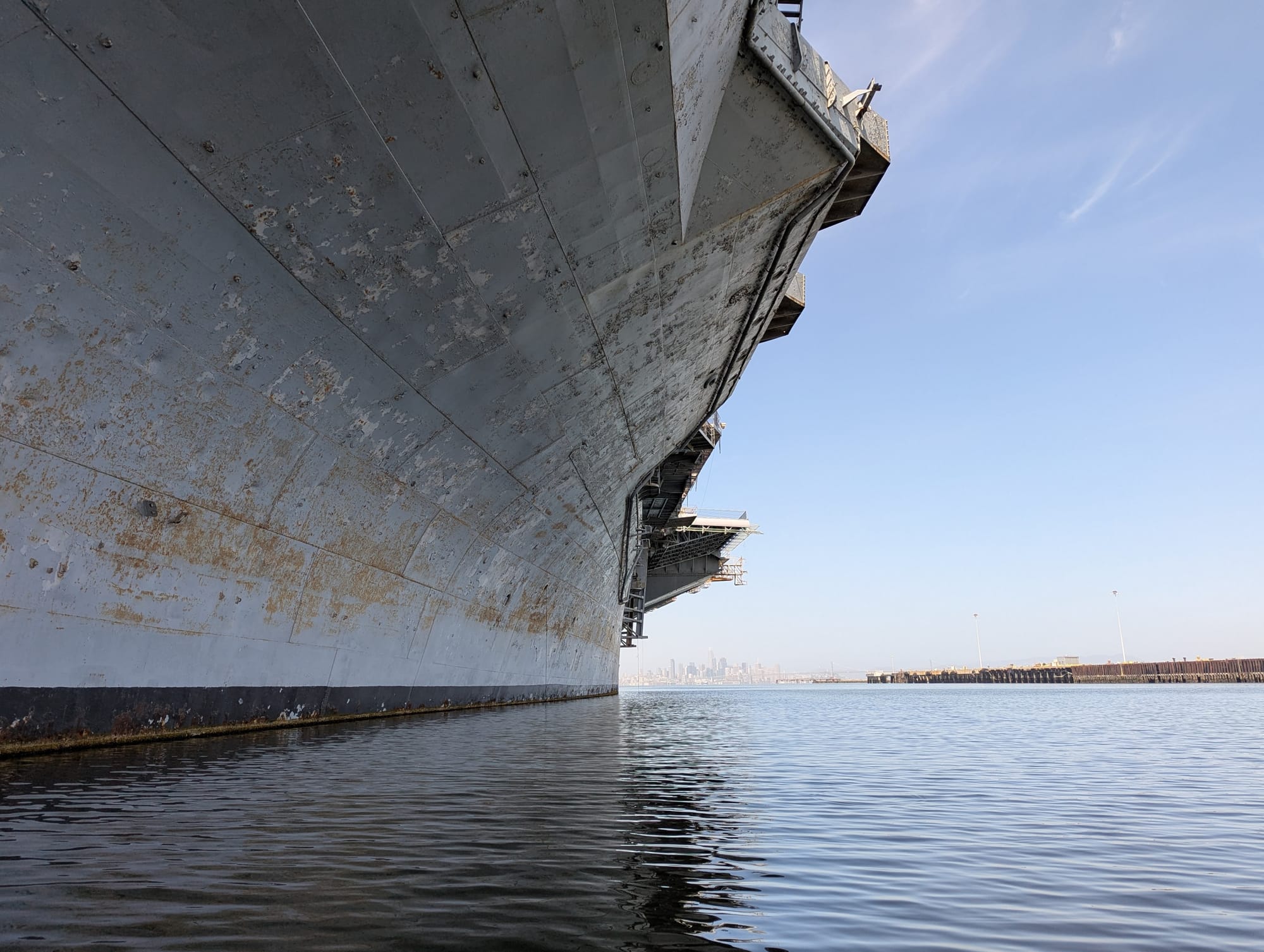the side of the boat, with the city in the background