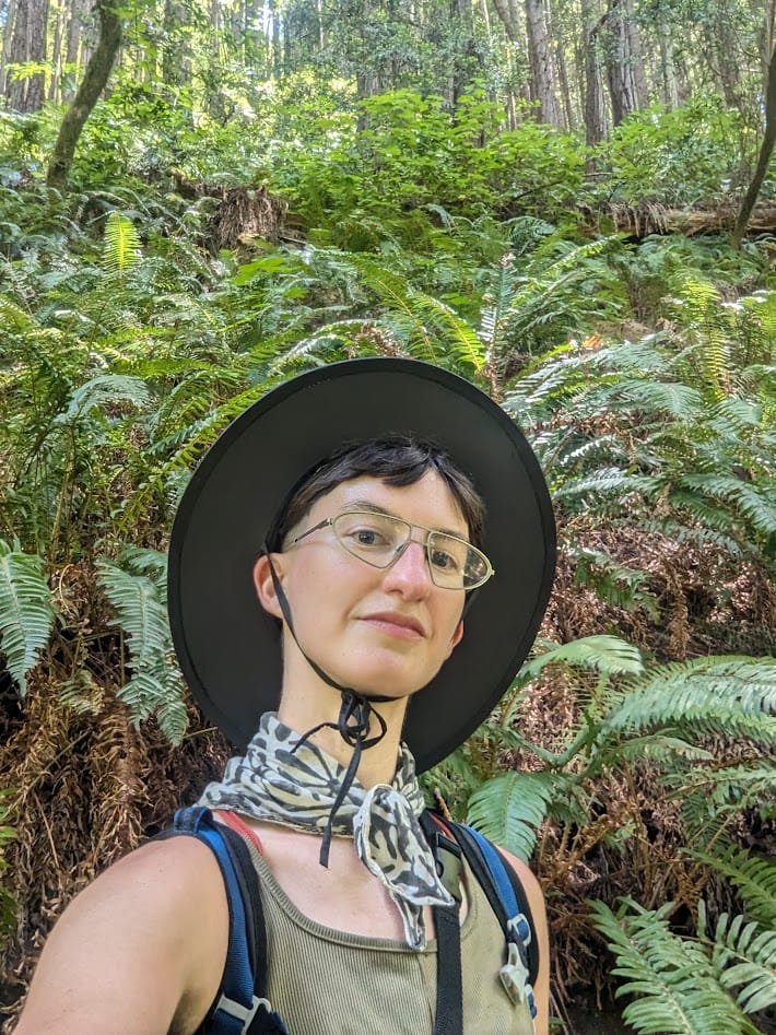 me in front of a wall of ferns