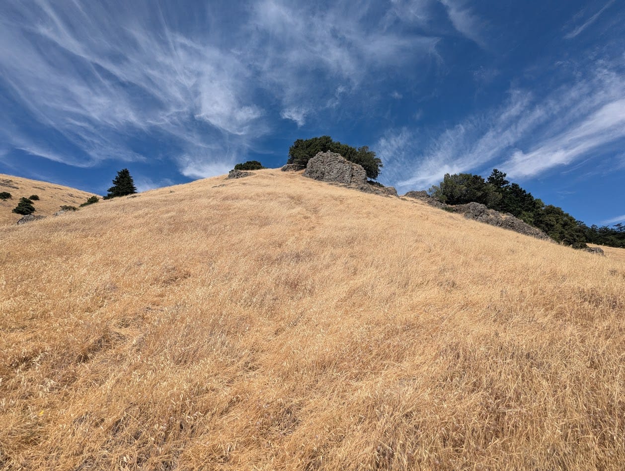 a very very steep hill, and cool wispy clouds