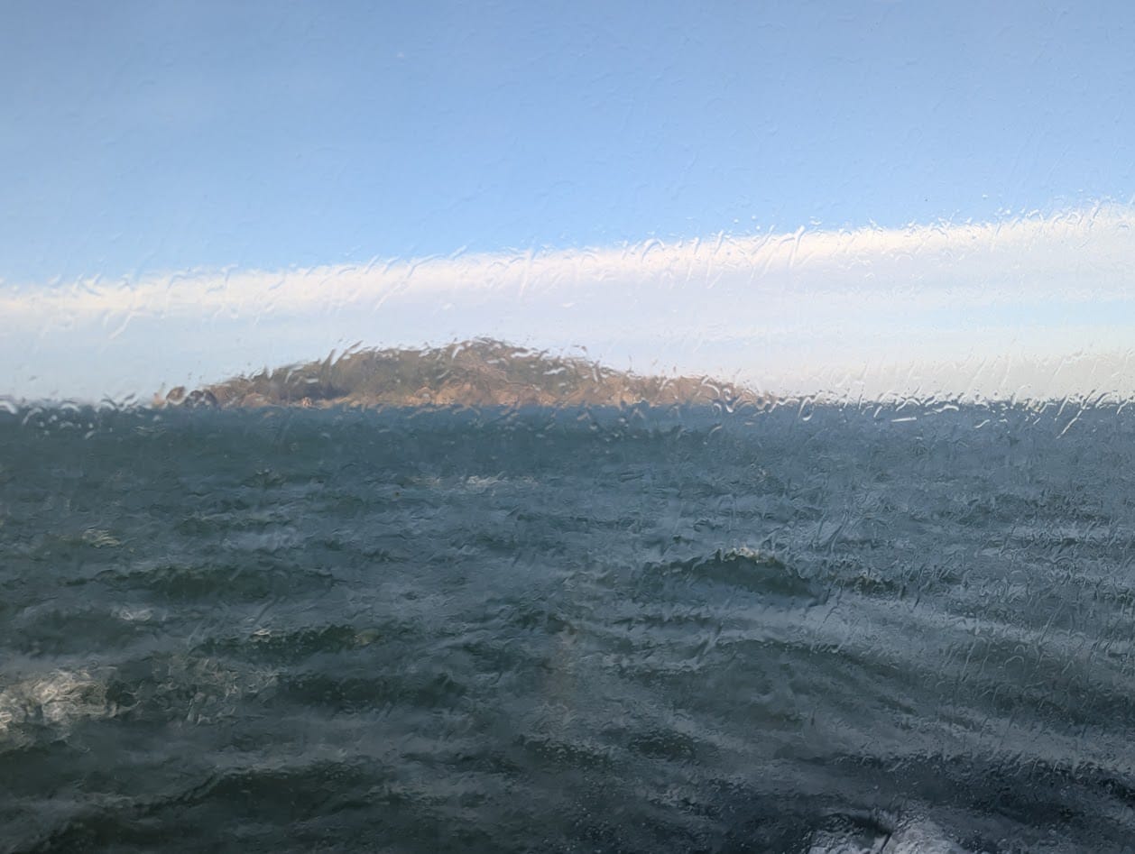 angel island through a wet ferry window