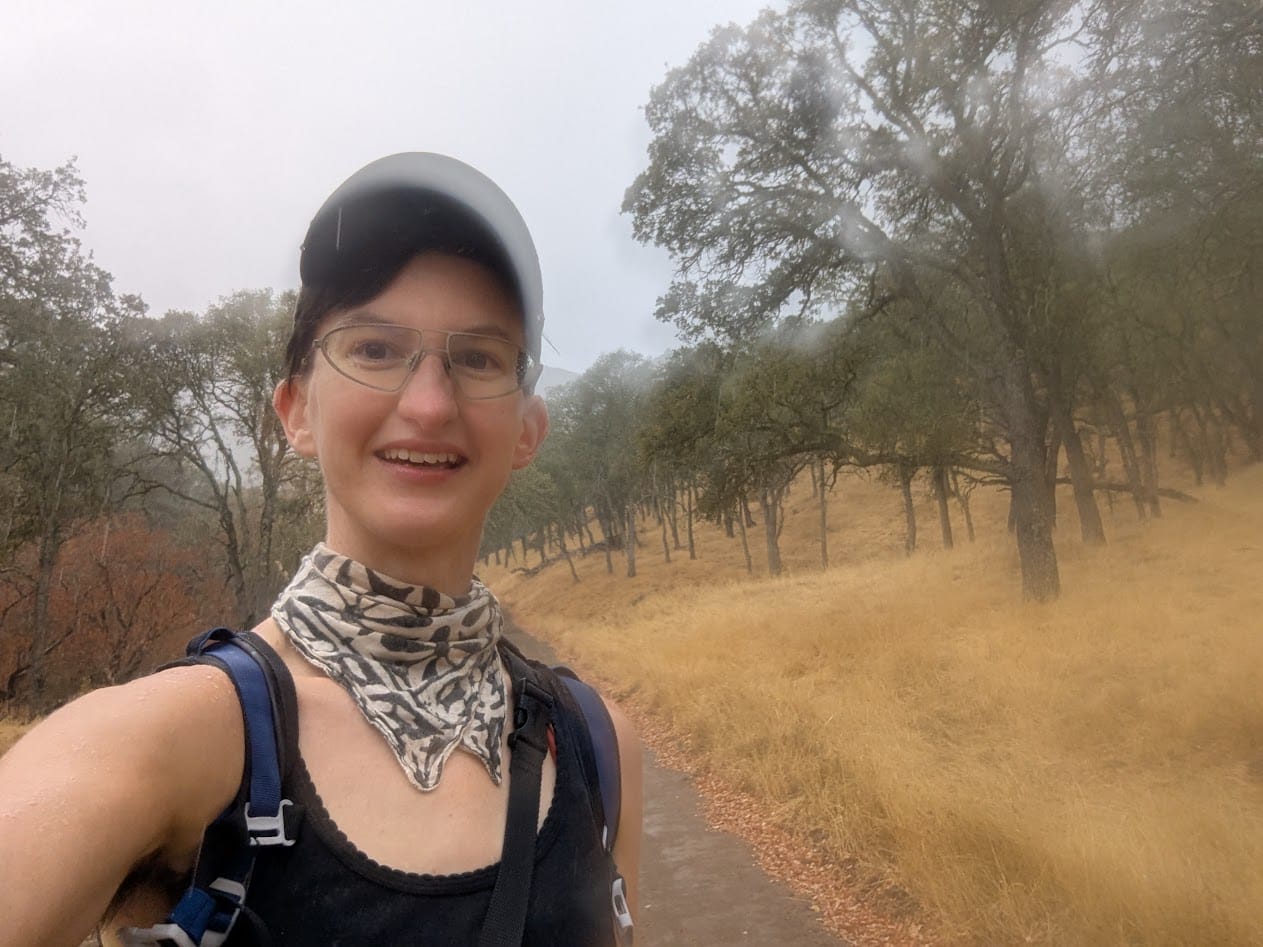 blurry me on a muddy trail, smiling