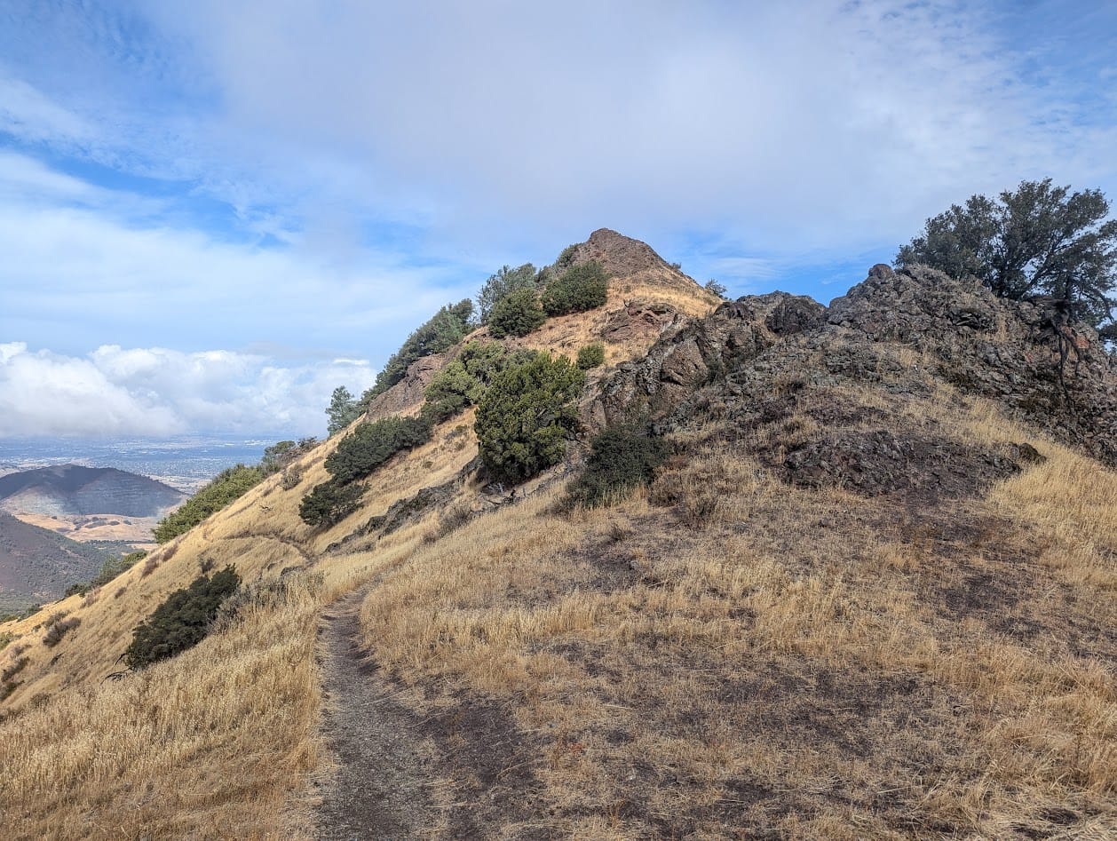 steep hill with a rock on top