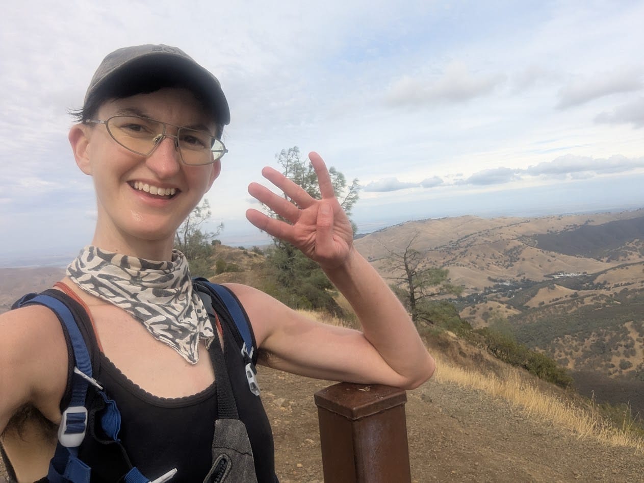 me on top of a mountain with 4 fingers up