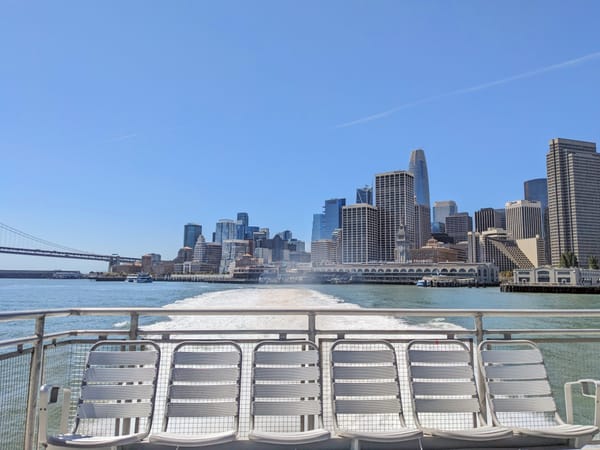 view of the san francisco skyline and part of the bay bridge from a ferry