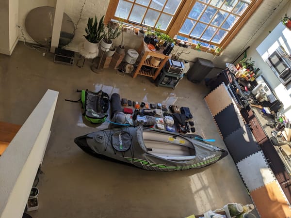 view from upstairs of the boat with a bunch of camping and boat supplies laid out in a grid